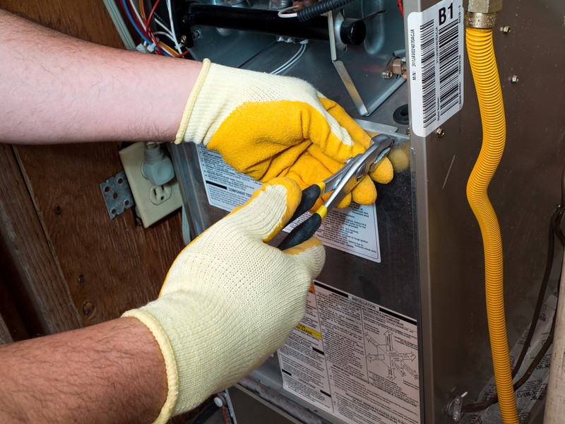 technician performing a furnace repair